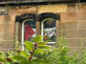 A free Palestine flag hanging in a window