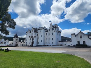 A very large, perfectly white castle against a blue cloudy sky