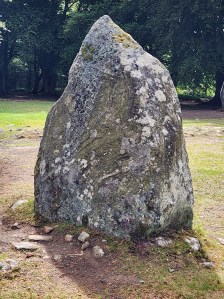 A large rock with a pointy head, about as tall as a person.