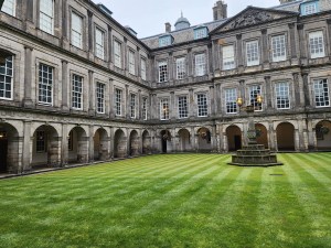 The inner courtyard at Holyrood, with a bright green lawn.