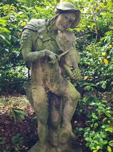 A statue of a man holding a fiddle in the Holyrood gardens