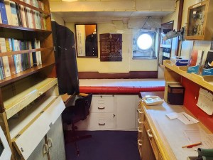 A small room with a desk that I believe belongs to the ship's doctor. (But I could be wrong.)