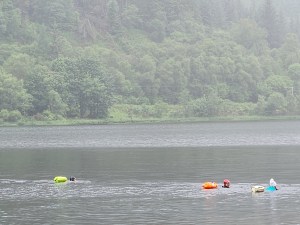 Swimmers on Loch Lubnaig with a mountain in the background