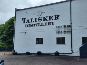 Sign on the side of the wall announcing Talisker Distillery