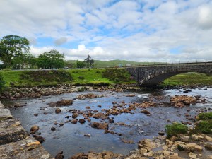 A stream between two Faery bridges, laden with rocks