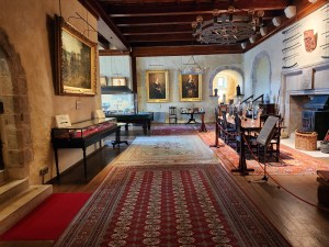 A long view of the Great Hall, with antiques and paintings.
