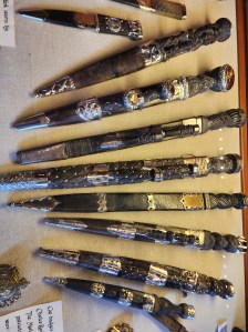 Ten small, fancy daggers in their sheaths in a glass case in Duart Castle