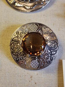 A large silver brooch with a huge smoky quartz jewel