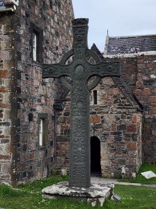 A tall Celtic stone cross in front of Iona Abbey. This is MacLean's Cross.