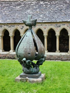 A large statute that looks something like a closed flower with a dove sitting on it.
