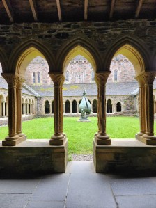 A view of a courtyard with arched entry ways in the foreground