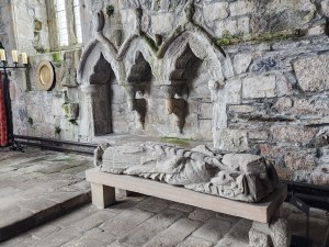 A statue lying down near the altar at the Iona Abbey