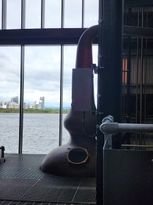 A large still with an "onion" bulge at the middle. In the background is a large window.