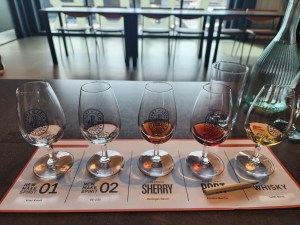 A flight of liquors: spirit, sherry, port, and table whisky in small whisky snifters