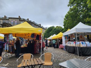 Two yellow tents and a white tent at the Leith Market