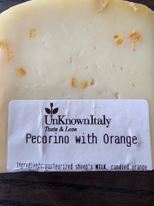 A wedge of pecorino cheese "with orange."